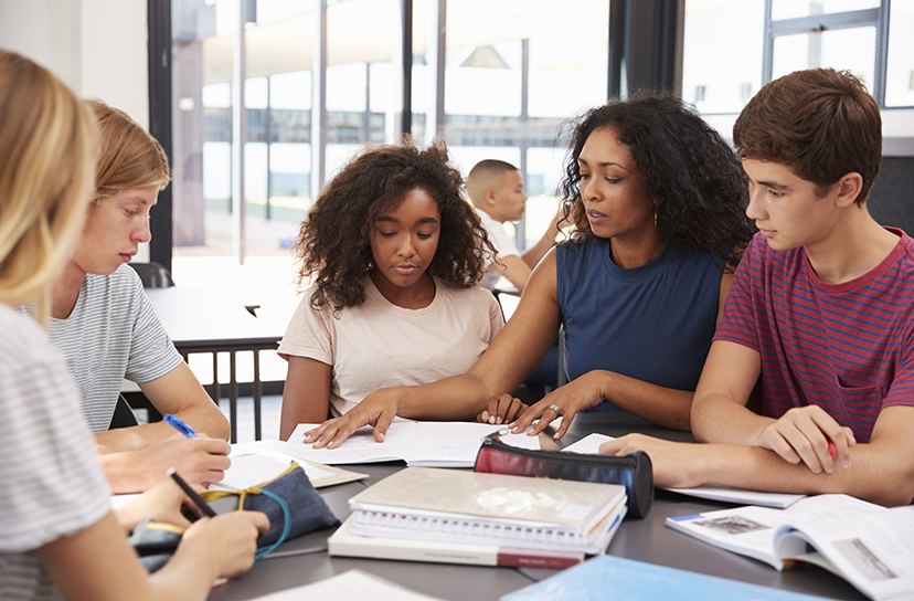 Photo of high schoolers working at table