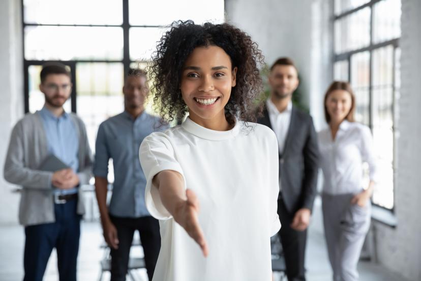 Welcoming group with outstretched hand