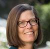 Caucasian woman with brown hair wearing glasses